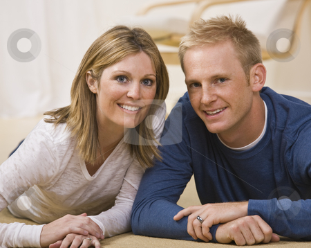 To use this stock image in your creative project, please select the size you need over to the right and click the "Add to Cart" button.
Your downloaded image will come with the Cutcaster watermark removed so don’t worry about the watermark you see on this page. Beautiful Couple Posing stock photo, A beautiful couple posing together. They are lying on the ground and are smiling directly at the camera. Horizontally framed shot. by Jonathan Ross