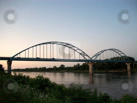 To use this stock image in your creative project, please select the size you need over to the right and click the "Add to Cart" button.
Your downloaded image will come with the Cutcaster watermark removed so don’t worry about the watermark you see on this page. The Blue Bridge stock photo, The Blue Bridge - still in use today , providing passage over the Missouri river . by JJ Havens