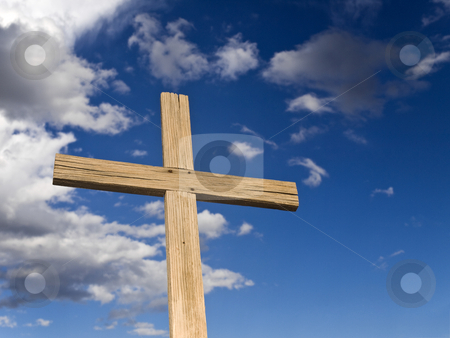 Wooden cross Wooden cross stock photo, A wooden cross over a blue sky with clouds. by Ignacio Gonzalez Prado