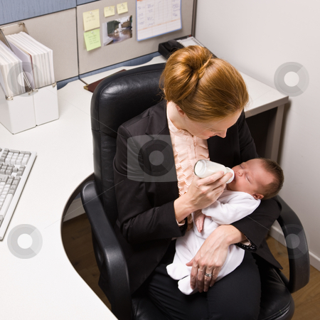 Businesswoman feeding baby at desk Businesswoman feeding baby at desk stock photo, Businesswoman feeding baby at desk by Jonathan Ross