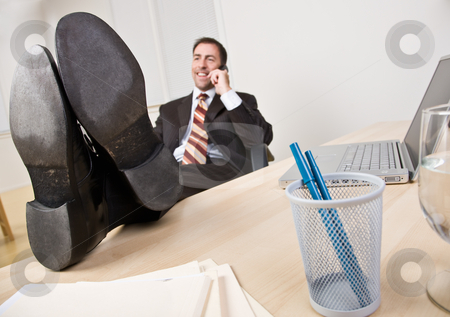 To use this stock image in your creative project, please select the size you need over to the right and click the "Add to Cart" button.
Your downloaded image will come with the Cutcaster watermark removed so don’t worry about the watermark you see on this page. Businessman talking on telephone with feet up stock photo, Businessman talking on telephone with feet up by Jonathan Ross