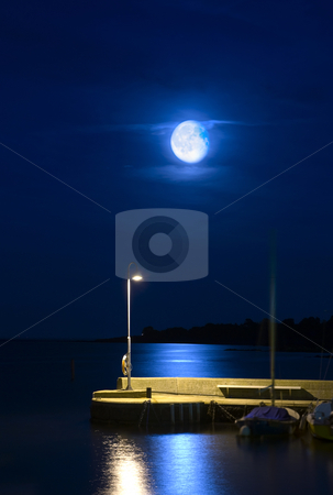 Rising moon Rising moon stock photo, Rising moon over a tranquil harbor pier by Corepics VOF