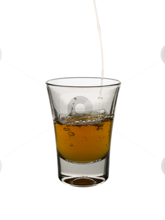 Shot of whisky Shot of whisky stock photo, Pouring a shot of whisky on white background. by Ignacio Gonzalez Prado