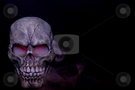 To use this stock image in your creative project, please select the size you need over to the right and click the "Add to Cart" button.
Your downloaded image will come with the Cutcaster watermark removed so don’t worry about the watermark you see on this page. Steaming skull stock photo, A Halloween prop skull with fog coming from it's eyes and nose. by Cora Reed