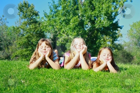 To use this stock image in your creative project, please select the size you need over to the right and click the "Add to Cart" button.
Your downloaded image will come with the Cutcaster watermark removed so don’t worry about the watermark you see on this page. Girls lying on grass stock photo, Girls lying on grass by Gregory Dean