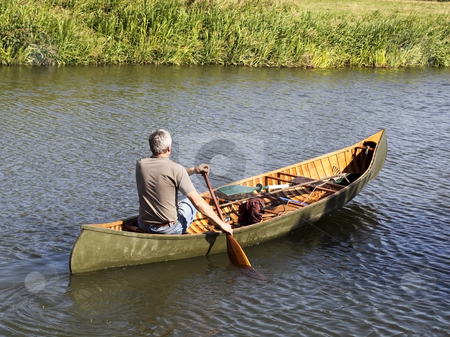 cutcaster-photo-100386278-man-in-a-canoe.jpg