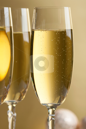 Glasses of champagne Glasses of champagne stock photo, Three glasses of champagne, christmas balls and ornaments in front of golden background by Alexander Zschach