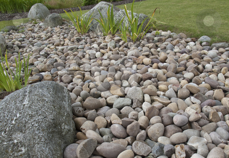 To use this stock image in your creative project, please select the size you need over to the right and click the "Add to Cart" button.
Your downloaded image will come with the Cutcaster watermark removed so don’t worry about the watermark you see on this page. Pebbles and a rockery stock photo, by Stephen Clarke