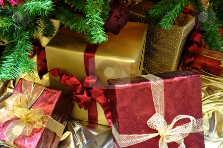 To use this stock image in your creative project, please select the size you need over to the right and click the "Add to Cart" button.
Your downloaded image will come with the Cutcaster watermark removed so don’t worry about the watermark you see on this page. Christmas Gifrts Under The Tree stock photo, Gold and red wrapped Christmas gifts under a decorated tree by Lynn Bendickson