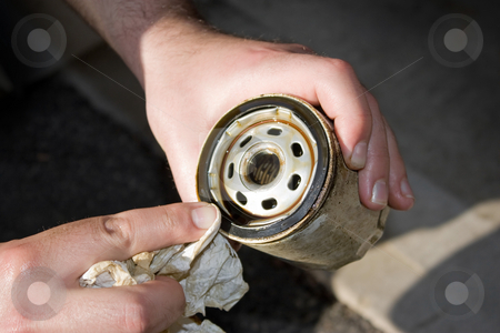 To use this stock image in your creative project, please select the size you need over to the right and click the "Add to Cart" button.
Your downloaded image will come with the Cutcaster watermark removed so don’t worry about the watermark you see on this page. Dirty Used Oil Filter stock photo, A backyard mechanic wipes the seal of a slightly used oil filter to reuse it for an additional 3000 miles. Others prefer to replace them each and every oil change. by Todd Arena