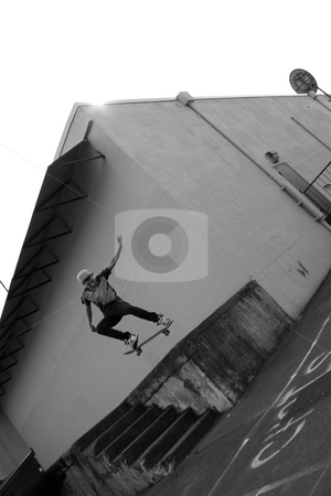 To use this stock image in your creative project, please select the size you need over to the right and click the "Add to Cart" button.
Your downloaded image will come with the Cutcaster watermark removed so don’t worry about the watermark you see on this page. Skateboarder Airborne stock photo, A young skateboarder launches off a concrete loading dock in an urban setting. by Todd Arena