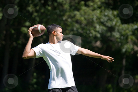 Man Throwing a Football Man Throwing a Football stock photo, A young man throwing a football outdoors. by Todd Arena