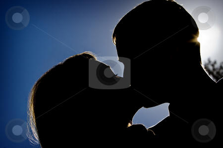To use this stock image in your creative project, please select the size you need over to the right and click the "Add to Cart" button.
Your downloaded image will come with the Cutcaster watermark removed so don’t worry about the watermark you see on this page. Summer's Kiss stock photo, Silhouette of a couple kissing by Ley Elliott