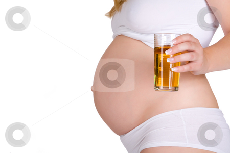 Presenting glass of apple juice in front of pregnant belly Presenting glass of apple juice in front of pregnant belly stock photo, Presenting a healthy drink in front of pregnant belly. Made in a studio environment on white background with Canon 5D by Frenk and Danielle Kaufmann