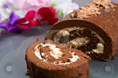 To use this stock image in your creative project, please select the size you need over to the right and click the "Add to Cart" button.
Your downloaded image will come with the Cutcaster watermark removed so don’t worry about the watermark you see on this page. Homemade chocolate roll with fresh flowers stock photo, Homemade chocolate roll with fresh flowers on a slate by Robert Anthony