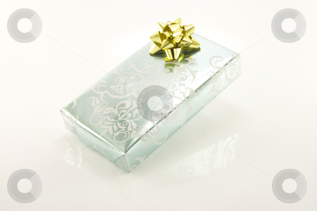 To use this stock image in your creative project, please select the size you need over to the right and click the "Add to Cart" button.
Your downloaded image will come with the Cutcaster watermark removed so don’t worry about the watermark you see on this page. Silver Wrapped Gift stock photo, Single shiny silver wrapped gift with a gold bow on a reflective white background by Keith Wilson