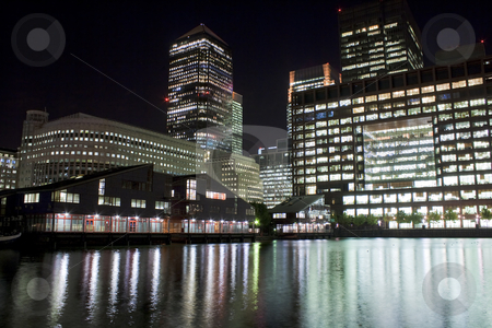 Canary Wharf skyscrapers in London at night Canary Wharf skyscrapers in London at night stock photo, Canary Wharf skyscrapers in London at night with reflections in the river by Karel Miragaya