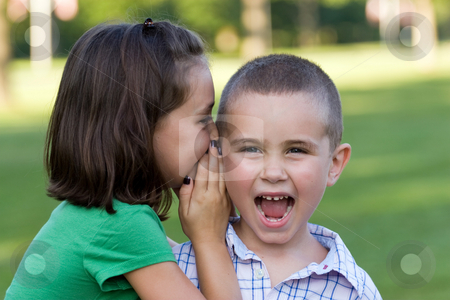 Kids Telling Secrets Kids Telling Secrets stock photo, A young girl telling her brother a secret. by Todd Arena