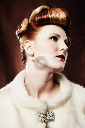 Woman Looking Up and Away Woman Looking Up and Away stock photo, A woman is wearing a fur coat and a brooch, and is looking up and away from the camera. Vertically framed shot. by Media Deva