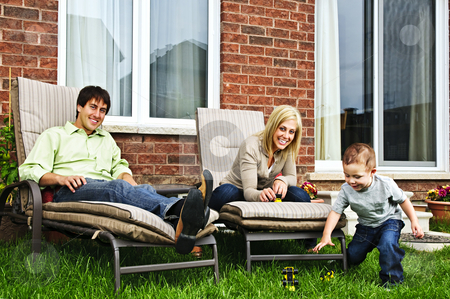 To use this stock image in your creative project, please select the size you need over to the right and click the "Add to Cart" button.
Your downloaded image will come with the Cutcaster watermark removed so don’t worry about the watermark you see on this page. Happy family relaxing at home stock photo, Happy family relaxing in backyard of new home with toddler by Elena Elisseeva