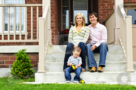 To use this stock image in your creative project, please select the size you need over to the right and click the "Add to Cart" button.
Your downloaded image will come with the Cutcaster watermark removed so don’t worry about the watermark you see on this page. Happy family at home stock photo, Young family sitting on front steps of house by Elena Elisseeva