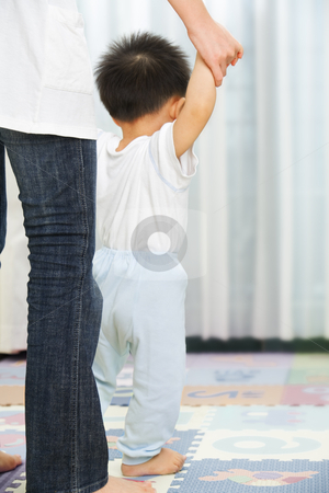 Mother guide her son to walk Mother guide her son to walk stock photo, Mother guide her little son to walk in bedroom by Rudyanto Wijaya