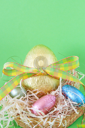 To use this stock image in your creative project, please select the size you need over to the right and click the "Add to Cart" button.
Your downloaded image will come with the Cutcaster watermark removed so don’t worry about the watermark you see on this page. Colorful wrapped chocolate Easter eggs stock photo, Assortment of chocolate Easter eggs wrapped in colorful paper in the basket with straw by Elena Weber (nee Talberg)