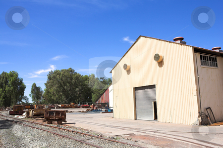To use this stock image in your creative project, please select the size you need over to the right and click the "Add to Cart" button.
Your downloaded image will come with the Cutcaster watermark removed so don’t worry about the watermark you see on this page. Industrial type warehouse and factory stock photo, Rusted metal mining wagons standing outside an industrial warehouse with train tracks running in front of the building. Blue sky and sunny day by Sean Nel