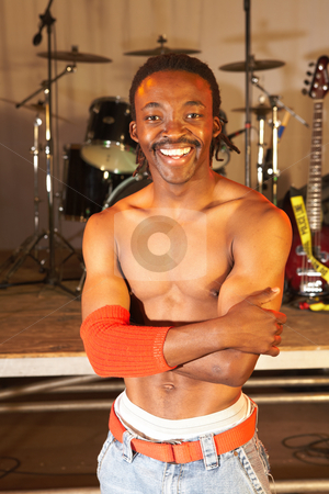 To use this stock image in your creative project, please select the size you need over to the right and click the "Add to Cart" button.
Your downloaded image will come with the Cutcaster watermark removed so don’t worry about the watermark you see on this page. African freestyle hip-hop dancer stock photo, Single African freestyle hip-hop dancer at a training session on stage with instruments in the background by Sean Nel