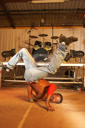 To use this stock image in your creative project, please select the size you need over to the right and click the "Add to Cart" button.
Your downloaded image will come with the Cutcaster watermark removed so don’t worry about the watermark you see on this page. African freestyle hip-hop dancer stock photo, Single African freestyle hip-hop dancer at a training session on stage with instruments in the background by Sean Nel