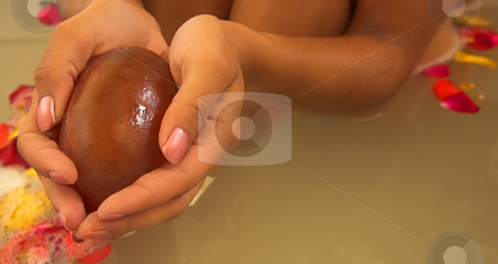 Woman #51 Woman #51 stock photo, Hands of a female holding a soap, bath in the background. Copy space. by Sean Nel