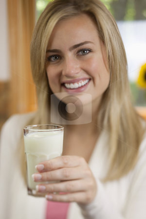 To use this stock image in your creative project, please select the size you need over to the right and click the "Add to Cart" button.
Your downloaded image will come with the Cutcaster watermark removed so don’t worry about the watermark you see on this page. Woman Drinking Milk stock photo, A young woman is holding a glass of milk and smiling at the camera. Vertically framed shot. by Edward Bock