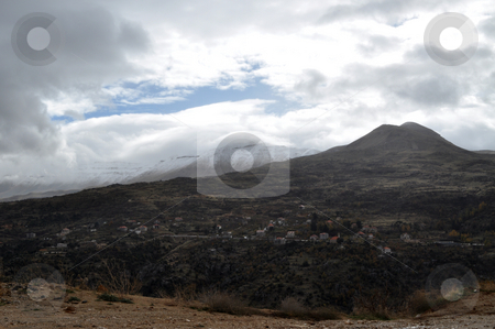 Two Mountains Two Mountains stock photo, A Village in Lebanon with Two mountains covered with snow by Tony Abdou