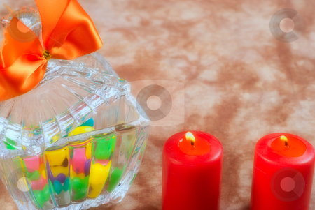 Romantic Candy Romantic Candy stock photo, A romantic scene with a glass bowl full of candy with two lit red candles by Richard Nelson