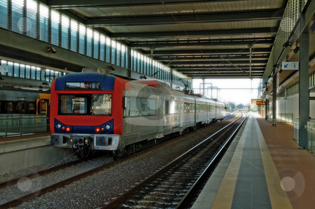 To use this stock image in your creative project, please select the size you need over to the right and click the "Add to Cart" button.
Your downloaded image will come with the Cutcaster watermark removed so don’t worry about the watermark you see on this page. Train at station stock photo, Commuter train arriving at a train station by Tito Wong