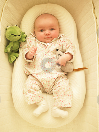 To use this stock image in your creative project, please select the size you need over to the right and click the "Add to Cart" button.
Your downloaded image will come with the Cutcaster watermark removed so don’t worry about the watermark you see on this page. Baby in Bassinet stock photo, Baby in bassinet with toys. Vertically framed shot. by Mog Ddl