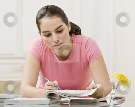 To use this stock image in your creative project, please select the size you need over to the right and click the "Add to Cart" button.
Your downloaded image will come with the Cutcaster watermark removed so don’t worry about the watermark you see on this page. Young Woman Doing Homework stock photo, Young woman doing homework. Horizontally framed shot. by Jonathan Ross