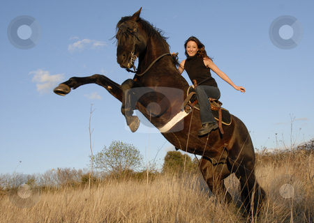 To use this stock image in your creative project, please select the size you need over to the right and click the "Add to Cart" button.
Your downloaded image will come with the Cutcaster watermark removed so don’t worry about the watermark you see on this page. Rearing stallion and girl stock photo, Rearing black stallion and happy young woman in a field by Bonzami Emmanuelle