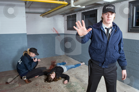 Back away Back away stock photo, Police officer keeping bystanders at a distance from a crime scene with a murdered woman in the background by Corepics VOF
