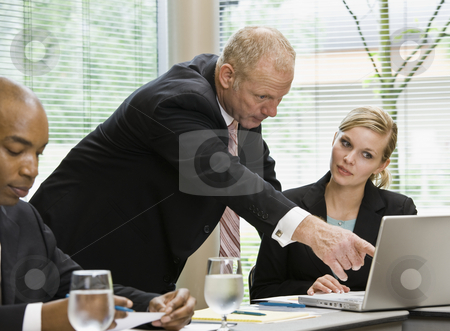 Businessman at Meeting Businessman at Meeting stock photo, Businessman at meeting pointing to laptop. Horizontally framed shot. by Jonathan Ross
