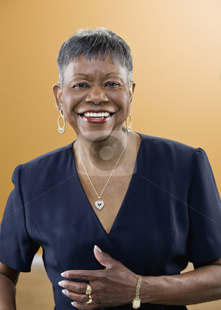 Older African American Woman Smiling Older African American Woman Smiling stock photo, Older African American woman smiling at camera. Vertically framed shot. by Jonathan Ross