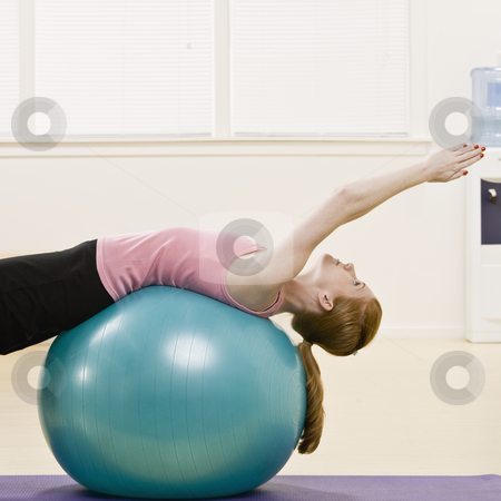 Young Woman Exercising Young Woman Exercising stock photo, Young woman exercising using fitness ball. Square format. by Jonathan Ross