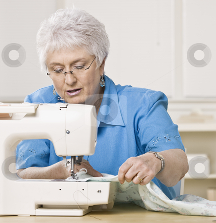 To use this stock image in your creative project, please select the size you need over to the right and click the "Add to Cart" button.
Your downloaded image will come with the Cutcaster watermark removed so don’t worry about the watermark you see on this page. Older Woman Sewing stock photo, Older woman working on sewing machine. Square framed shot. by Jonathan Ross