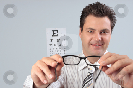 To use this stock image in your creative project, please select the size you need over to the right and click the "Add to Cart" button.
Your downloaded image will come with the Cutcaster watermark removed so don’t worry about the watermark you see on this page. Optometrist holding eye frames stock photo, An optometrist putting eyeglasses spectacles on a customer patient. by Leah-Anne Thompson