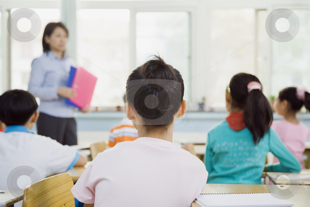 To use this stock image in your creative project, please select the size you need over to the right and click the "Add to Cart" button.
Your downloaded image will come with the Cutcaster watermark removed so don’t worry about the watermark you see on this page. Classroom of Students Watching Teacher stock photo, Classroom with teacher and students. The teacher is viewable from the front and children are viewable from behind. Horizontally framed shot. by Paul Burns