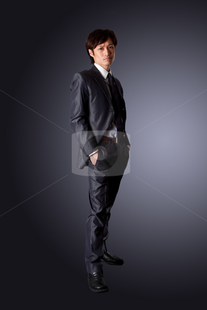 Successful Asian business man Successful Asian business man stock photo, Successful Asian business man standing with confidence and hands in pockets, isolated. by Paul Hakimata