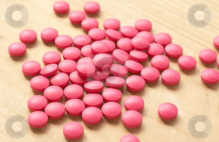cutcaster-photo-100543926-Pink-pills-on-brown-background-Shallow-depth-of-field.jpg