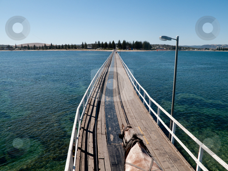 To use this stock image in your creative project, please select the size you need over to the right and click the "Add to Cart" button.
Your downloaded image will come with the Cutcaster watermark removed so don’t worry about the watermark you see on this page. Old pier at Granite Island and Victor Harbor stock photo, Wooden pier and railway track at Granite Island and Victor Harbor near Adelaide in Australia by Steven Heap