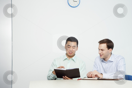 Handsome Young Businessmen Reviewing Day Planner Handsome Young Businessmen Reviewing Day Planner stock photo, Handsome young businessmen review information in day planers. Horizontal shot. by Paul Burns