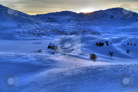 To use this stock image in your creative project, please select the size you need over to the right and click the "Add to Cart" button.
Your downloaded image will come with the Cutcaster watermark removed so don’t worry about the watermark you see on this page. Snowy mountains stock photo, Winter landscape in the Norwegian mountains by Kjersti Jorgensen